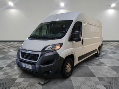 la camionnette blanche est garée dans une grande pièce au sol en damier
