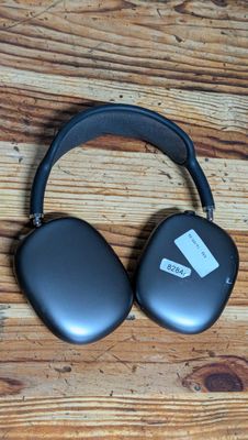 an image of a pair of headphones sitting on top of a wooden table
