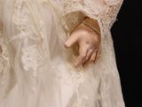 a woman in a wedding dress holding her hands out