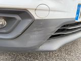 a close up of a car ' s front bumper with a number plate on it