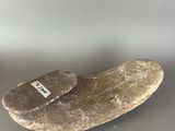 a rock with a tag on it sitting on a table