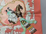 a pink scarf with a picture of a woman and a horse on it