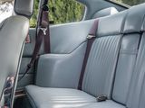 a seat in the back of a car with a seat belt