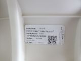a close up of a white toilet with a qr code on the seat