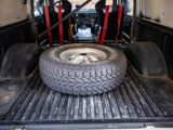 a truck bed with a tire in the back of it