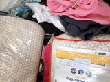 a pile of luggage sitting on top of a bed