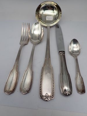 a lot of silver spoons and forks on the table