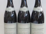 three bottles of wine sitting on top of a white table
