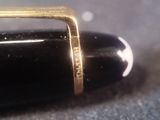 a close up of a fountain pen with a ring on it