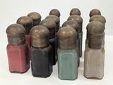 a lot of bottles of different colors on a white surface