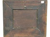 an old wooden picture frame with a small hole in the middle of it