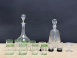 a lot of glasses and a decanter on a table