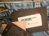the back pocket of a pair of jeans with a tag on it