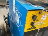 a machine that is sitting on a cart in a warehouse
