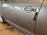 a close up of a car door handle with a sticker on it