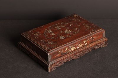 an old wooden box sitting on top of a black surface
