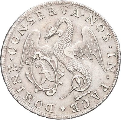 a close up of a silver coin with a dragon on it