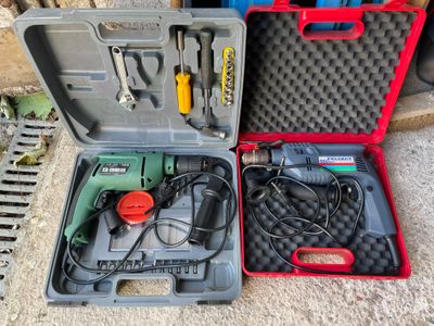 two tools in a case sitting on the ground