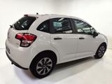 the rear end of a white car is shown in a showroom