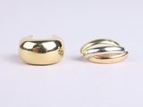 two gold and silver rings sitting on top of each other