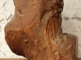 a wooden sculpture of a man with a beard on a shelf