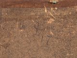 an old suitcase with writing on it sitting on the ground
