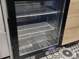 a glass door refrigerator in a kitchen with tile flooring
