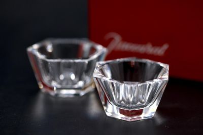 two small glass bowls sitting next to each other on a table