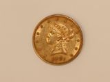 a close up of a gold coin on a white surface