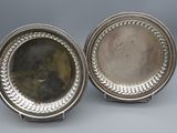 a pair of silver plated dishes with beaded rims