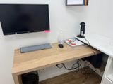 a computer desk with a monitor and keyboard on it