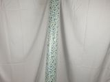 a close up of a white curtain with a blue and green tie