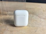 an apple airpods sitting on top of a wooden table