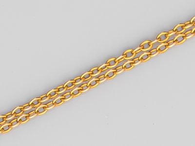 a close up of a gold chain on a white background
