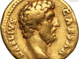a gold coin with a head of a man wearing a crown