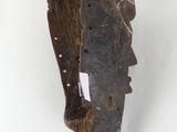 an image of a piece of wood with a face carved into it