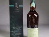 the bottle of lagavulin is next to a box of wine