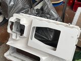 a white microwave sitting on top of a pile of trash