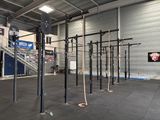 a gym area with a bunch of ropes hanging from the ceiling