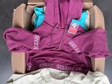 a cardboard box filled with clothing and a pair of shoes