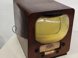 an old fashioned television with a yellow screen on a table