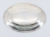 a silver plate on a white surface with a white background