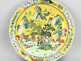 a yellow plate with a picture of a tree on it