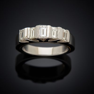 a close up of a diamond ring on a black surface