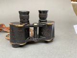 a pair of binoculars sitting on a table next to a bowl