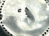 a close up of a metal object with holes in it