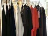 a lot of clothes hanging on a rack in a store