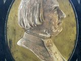 painting of a bust of a woman in a black frame