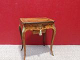 dollhouse miniature table with a red wall and white tile floor