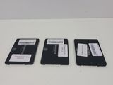 three hard drives sitting on top of a white table next to each other